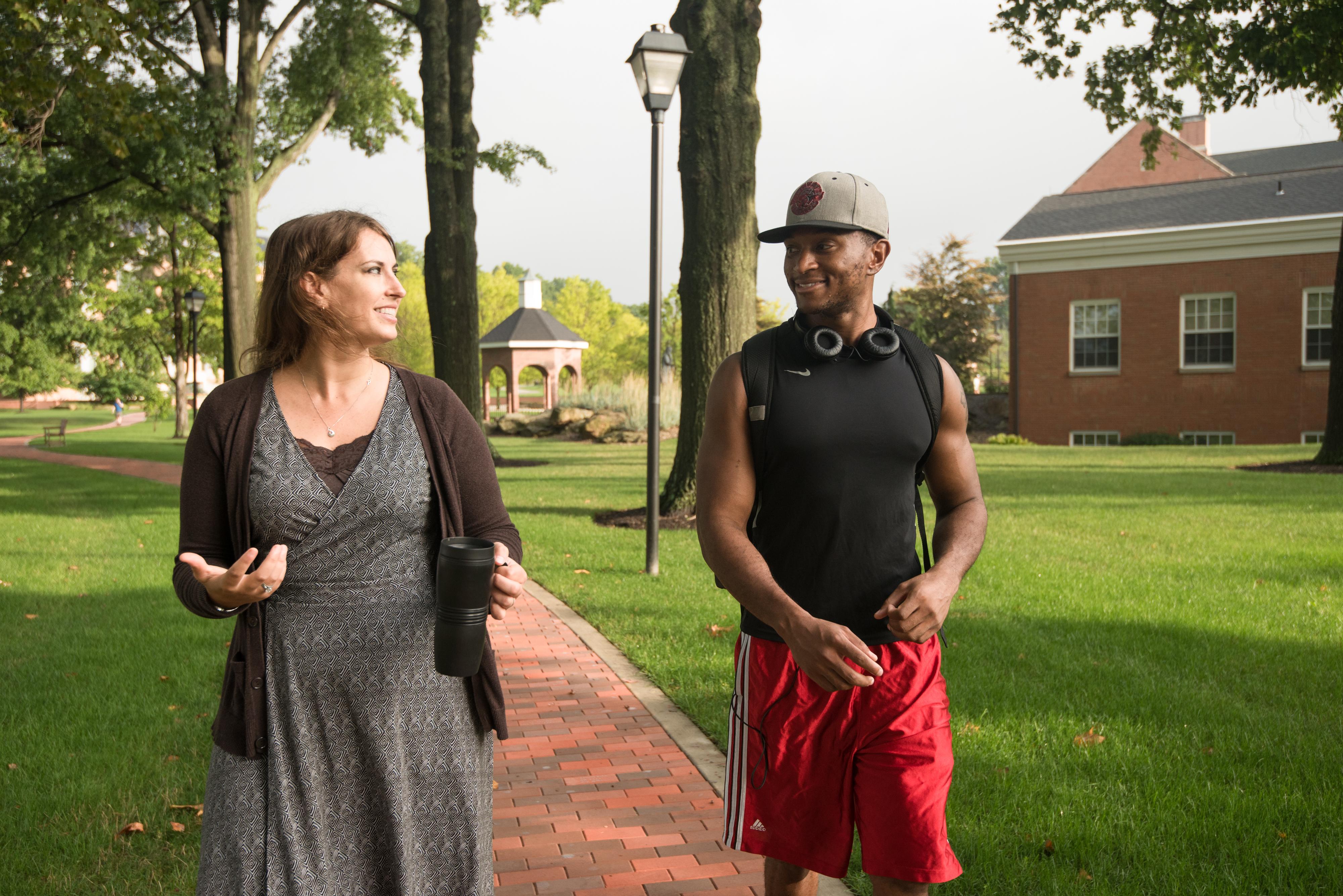 Student and Faculty member walking on campus